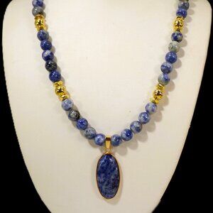 Blue sodalite stone pendant necklace with an oval pendant and gold accent beads